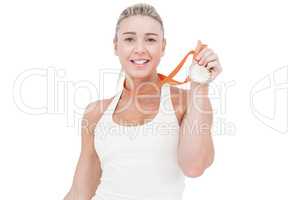 Happy female athlete holding medal