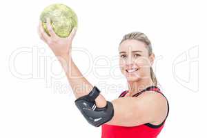 Female athlete with elbow pad holding handball