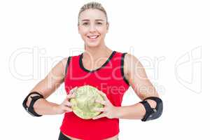 Female athlete with elbow pad holding handball