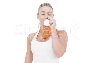 Happy female athlete kissing medal