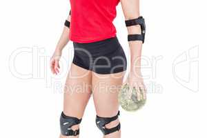 Female athlete with elbow pad holding handball