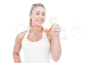 Happy female athlete holding medal