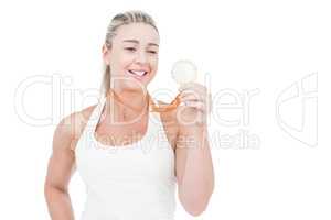 Happy female athlete holding medal