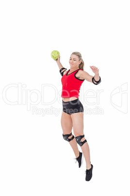 Female athlete with elbow pad throwing handball