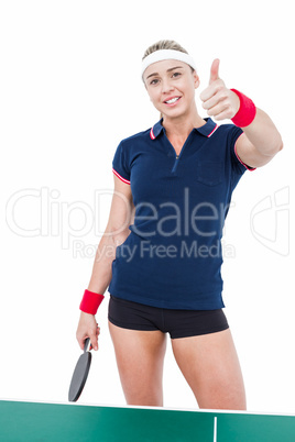 Female athlete playing ping pong and showing thumbs up