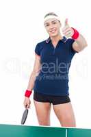 Female athlete playing ping pong and showing thumbs up