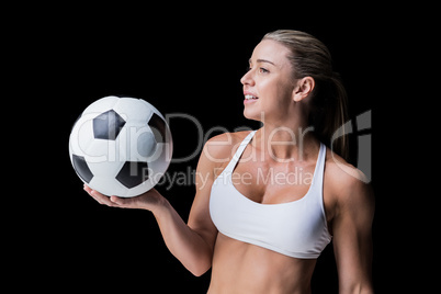 Female athlete holding a soccer ball