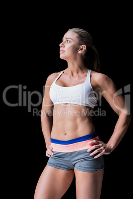 Female athlete posing with hands on hip Female athlete posing with hands on hip
