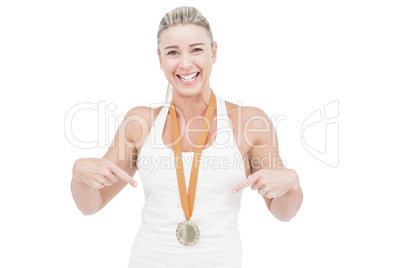 Female athlete pointing her medal