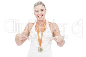 Female athlete pointing her medal