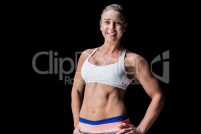 Female athlete posing with hands on hip