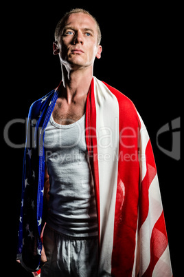 Athlete with american flag wrapped around his body