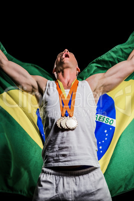 Athlete posing with gold medals after victory