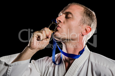 Fighter kissing his gold medal