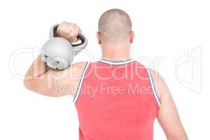 Bodybuilder lifting heavy kettlebell