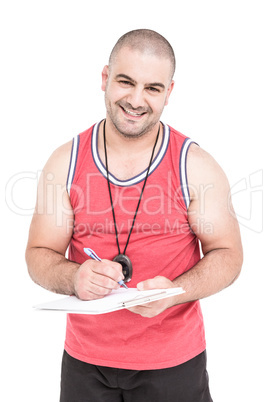 Athlete writing on clipboard