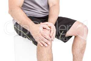 Athlete clutching knee in excruciating pain