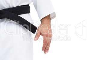 Close-up of karate black belt on white uniform