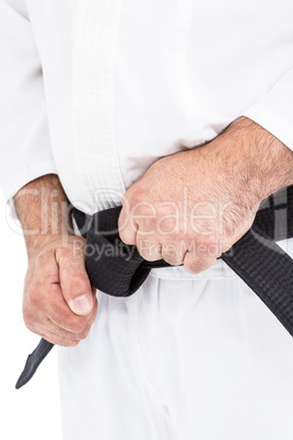 Fighter tightening karate belt