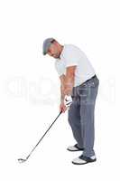 Golfplayer about to swing a golf ball