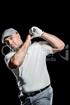 Portrait of golf player taking a shot