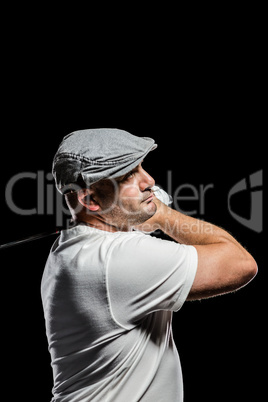 Portrait of golf player taking a shot