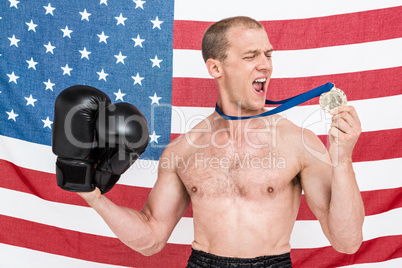 Excited boxer looking at his gold medal