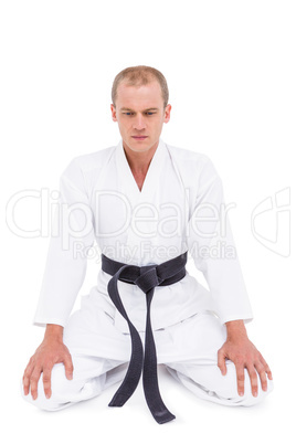 Front view of karate fighter meditating