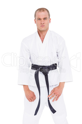 Confident fighter standing against white background
