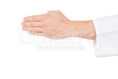 Karate player making hand gesture on white background