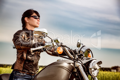 Biker girl sitting on motorcycle