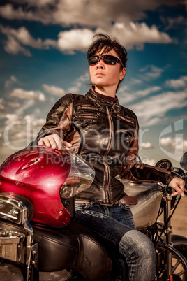 Biker girl sitting on motorcycle