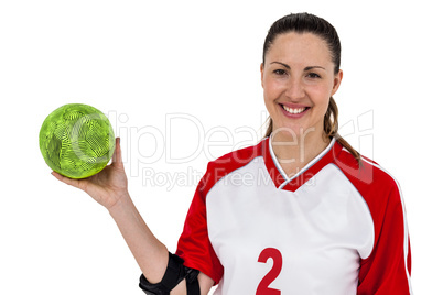 Sportswoman posing with ball