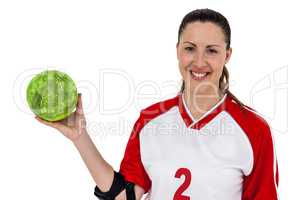 Sportswoman posing with ball