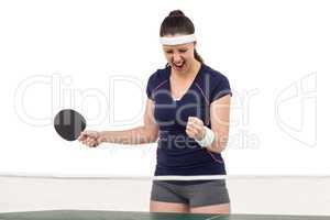 Female table tennis player posing after victory