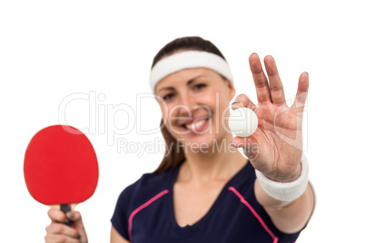 Female athlete holding table tennis paddle and ball