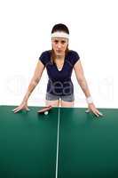 Angry female athlete leaning on hard table