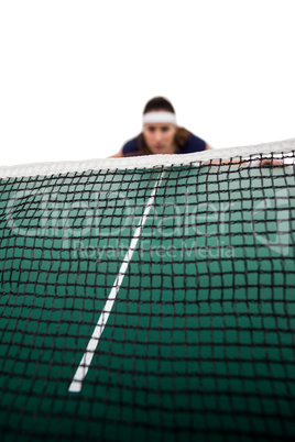 Tennis player behind net