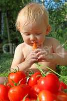 baby eats carrot and ripe tomatoes