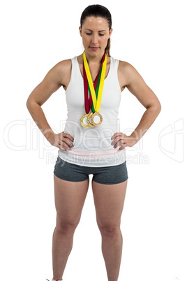 Athlete posing with gold medals around his neck