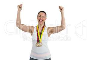 Female athlete posing with gold medal after victory