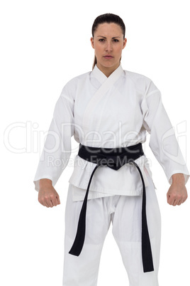 Female karate player posing on white background