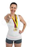 Female athlete posing with gold medals around his neck