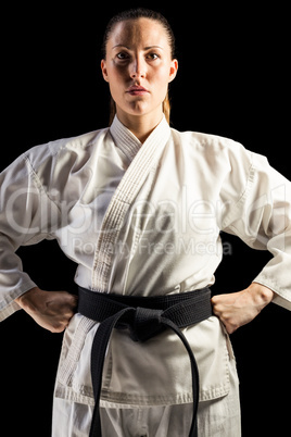 Female fighter standing with hand on hip