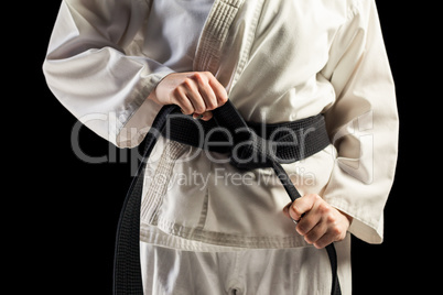 Fighter tightening karate belt