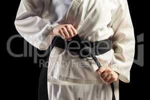 Fighter tightening karate belt