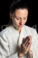 Close-up of female karate fighter meditating
