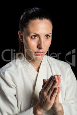 Close-up of female karate fighter meditating