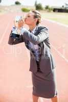 Happy businesswoman kissing her trophy