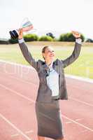 Happy businesswoman holding up a trophy